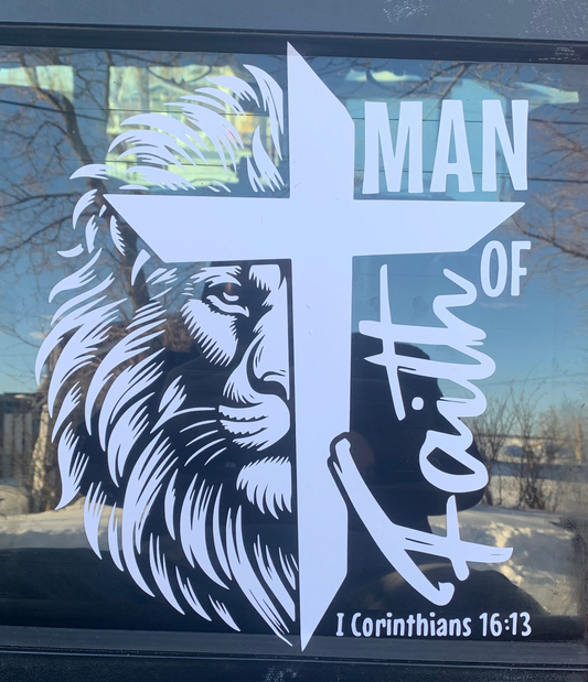 Decal with lion head, cross, and 'Man of Faith' text on a car window.