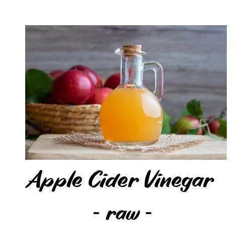Glass jar of apple cider vinegar with apples in the background