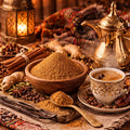 Spices, an Arabic Coffee pot, and a cup of coffee on a decorative table setting with a bowl of Arabic Coffee Spice