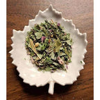 Bush Fire Chai mix on a white leaf-shaped dish on a wooden surface