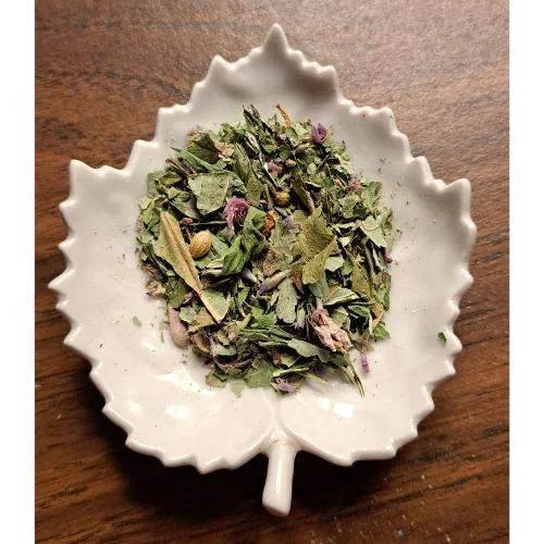 Bush Fire Chai mix on a white leaf-shaped dish on a wooden surface