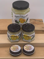 Jars of Triple H Homestead calendula salve on a wooden surface