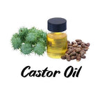 Bottle of castor oil with castor beans and leaves on a white background
