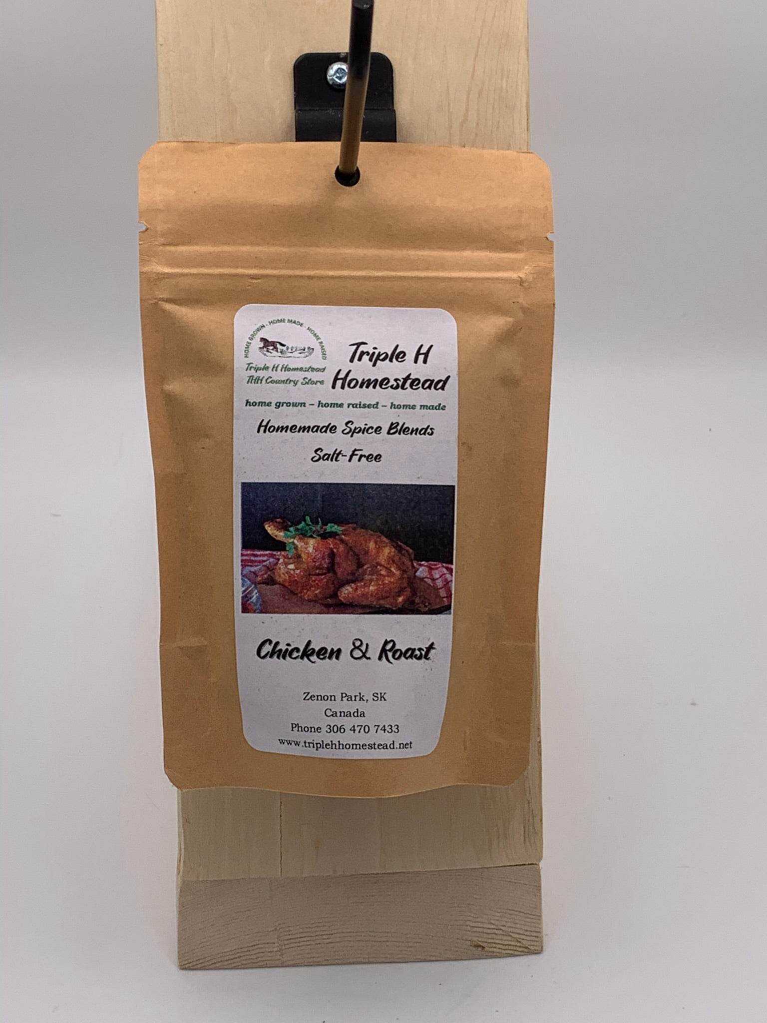 Packaged spice blend labeled 'Triple H Homestead' on a wooden board with a white background