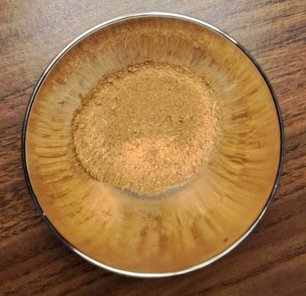 Metal bowl with Chinese 5 Spice mix on a wooden surface