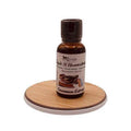 Bottle of cinnamon extract on a wooden coaster with a white background
