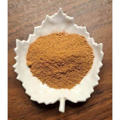 Dandelion Mocha Latte powder in a white leaf-shaped container on a wooden surface