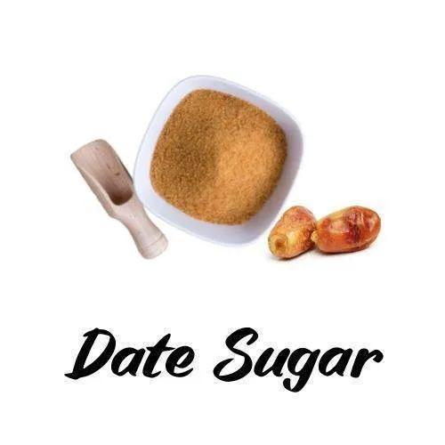 Date sugar in a bowl with a wooden scoop and two dates on a white background, labeled 'Date Sugar'.
