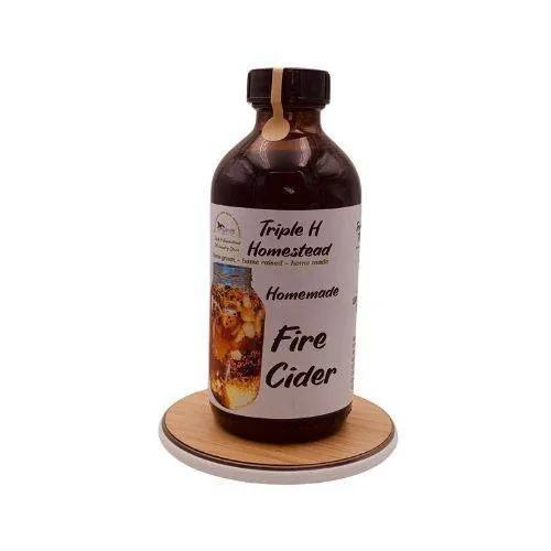 Bottle of Triple H Homestead Homemade Fire Cider on a white background