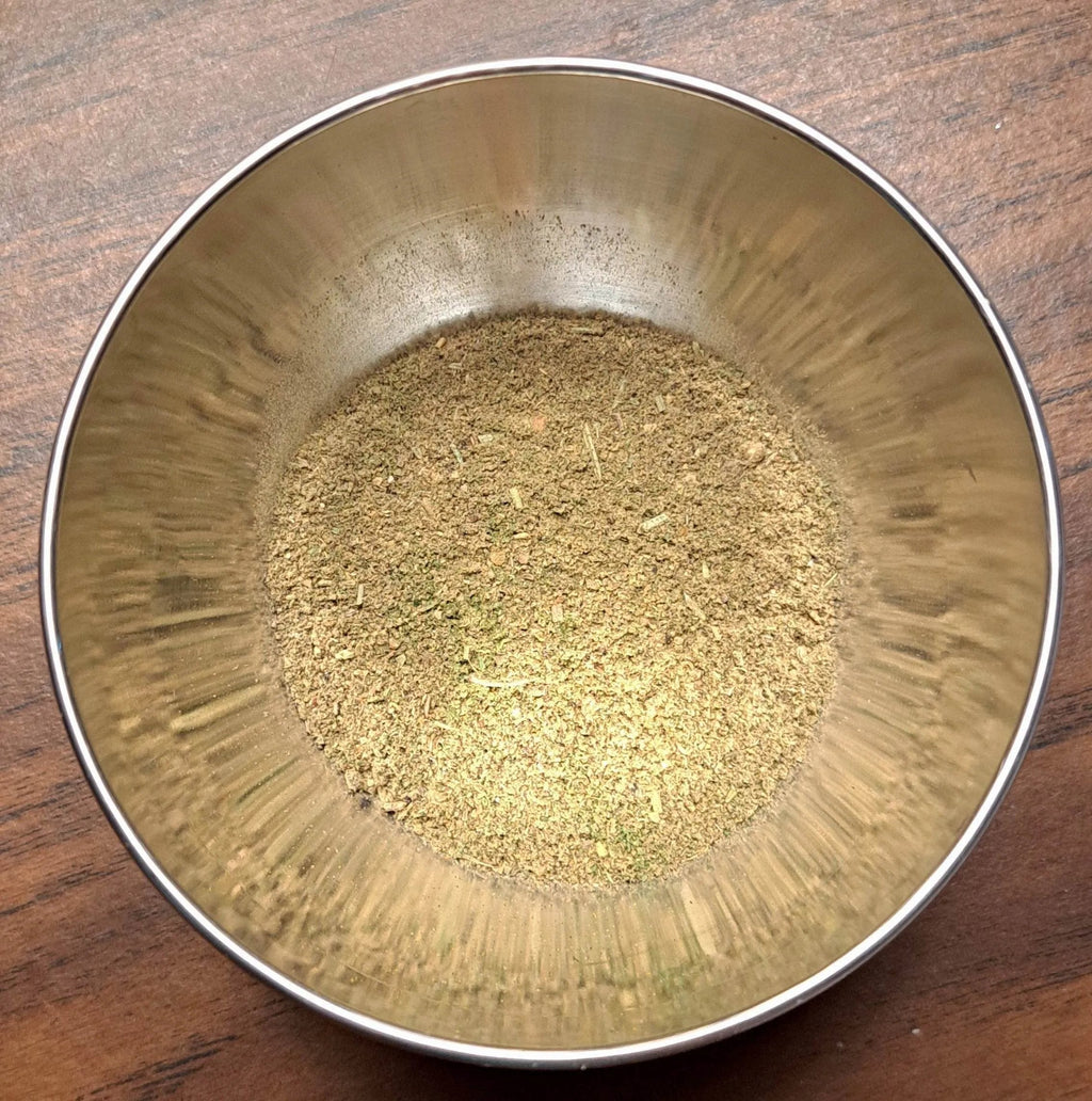 Metal bowl with Fish Blend on a wooden surface