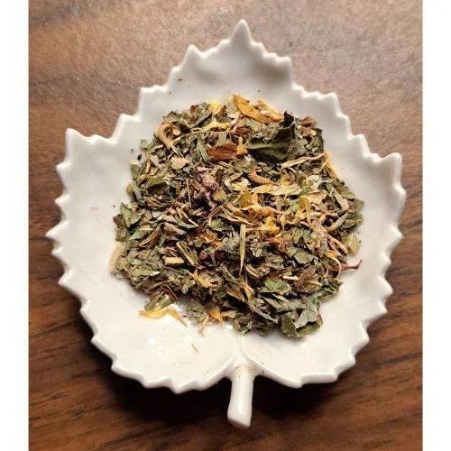 Good Morning Tea leaves on a white leaf-shaped ceramic dish on a wooden surface