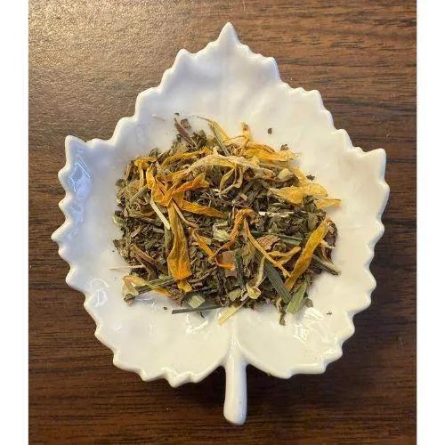 Healthy Liver tea leaves in a white leaf-shaped bowl on a wooden surface