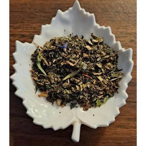 Immune Boopst herbs on a white leaf-shaped bowl on a wooden surface