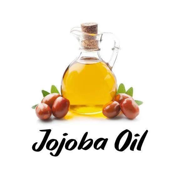 Bottle of jojoba oil with jojoba seeds on a white background