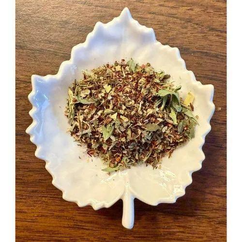 Magnesium Boost Herbal mix in a white decorative bowl on a wooden surface