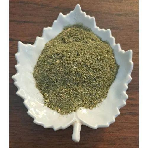 Nourishing Green Latte powder on a white leaf-shaped dish on a wooden surface