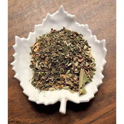 Nursing Mom Herbal tea leaves in a white ceramic leaf-shaped bowl on a wooden surface