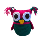 Crocheted owl toy with pink head and green body on a white background
