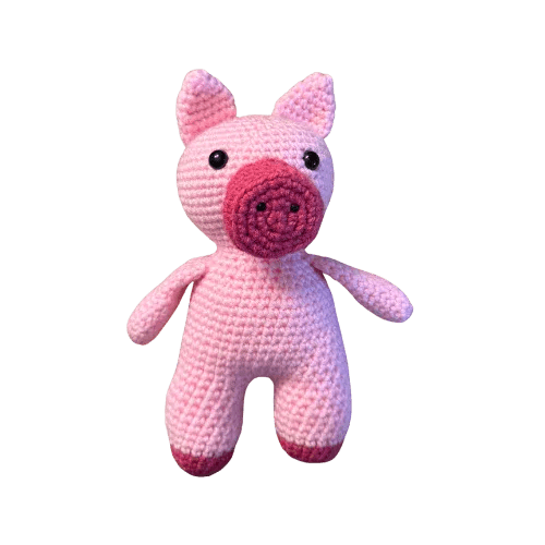 Pink crochet pig toy on a transparent background