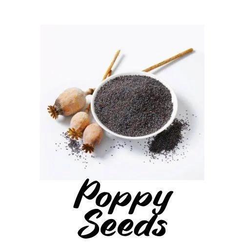 Poppy seeds in a bowl with poppy bulbs on a white background