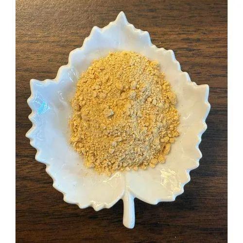 White ceramic dish with Pumpkin Pie Latte powder on a wooden surface