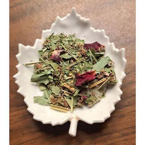 Saskatchewan Bliss Herbal tea mix on a decorative white plate with a wooden background