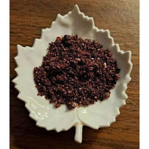 White leaf-shaped dish with Saskatoon White Chocolate Latte on a wooden surface