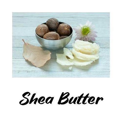 Shea butter with shea nuts and a flower on a light wooden background