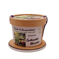 Container of Triple H Homestead herbal tea with decorative lid on a white background