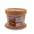Container of Triple H Homestead Herbal Tea with a wooden coaster on a white background