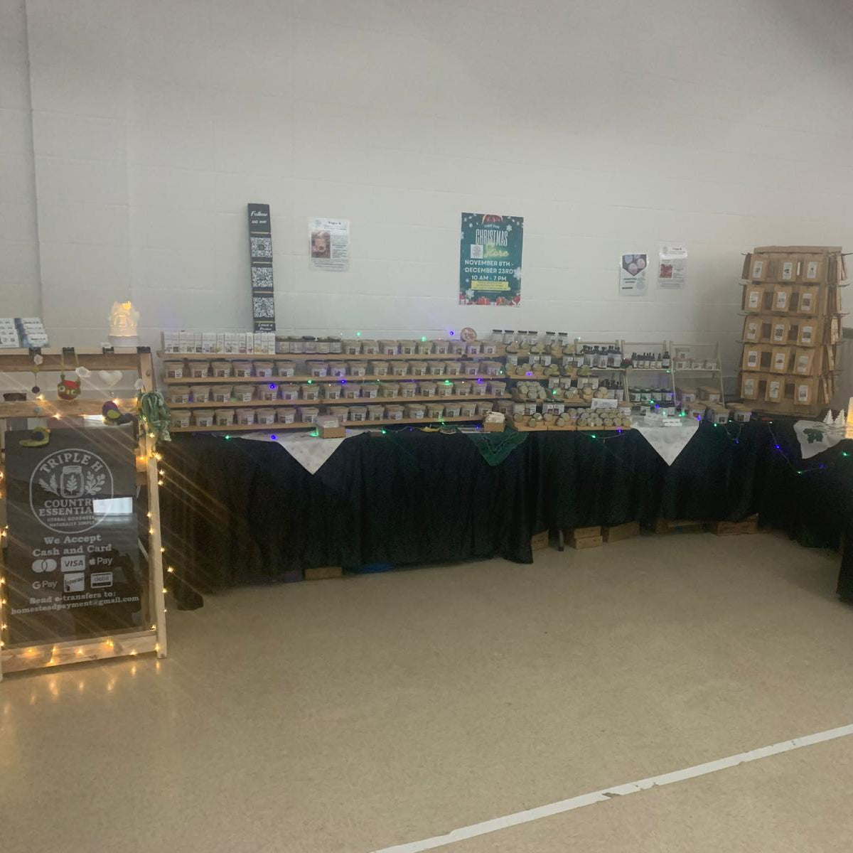 Event setup with tables, chairs, and decorative elements in a large room.