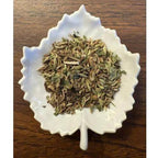 Tummy Tamer on a white ceramic leaf-shaped dish on a wooden surface