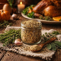 Jar of Turkey Rub with a wooden spoon on a rustic table with a roasted turkey and pumpkins.