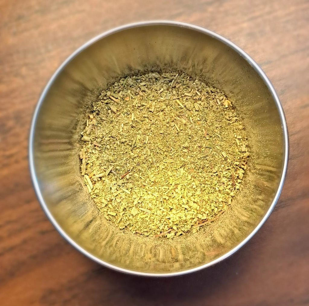 Metal bowl filled with Turkey Rub on a wooden surface