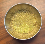 Metal bowl filled with Turkey Rub on a wooden surface