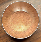 Metal bowl filled with Whimsical Brownie Friend spice mix on a wooden surface
