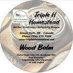 Triple H Homestead Wood Balm container with label on a wooden background